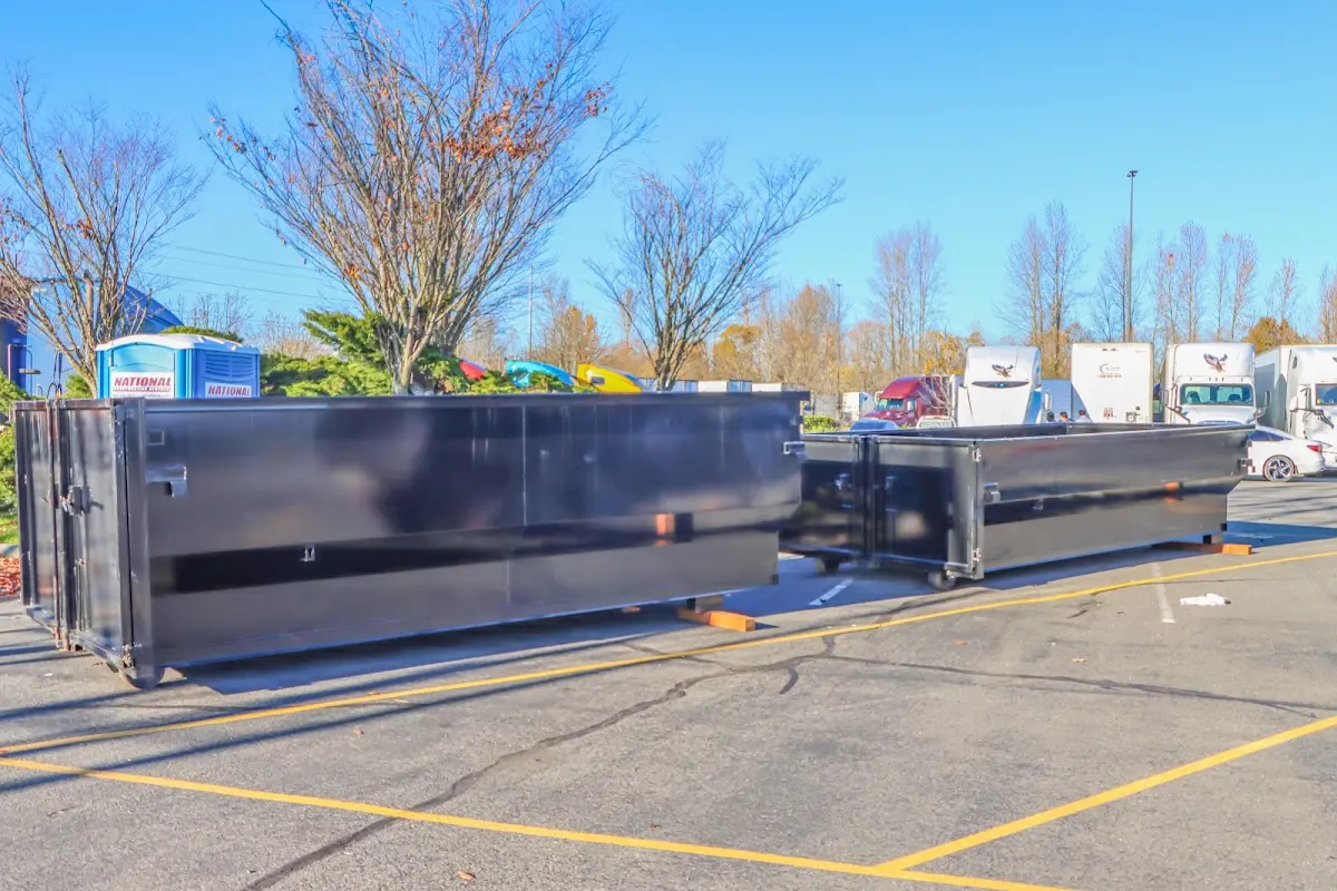 Professional dumpster rental service with roll-off container on residential driveway in Lewiston